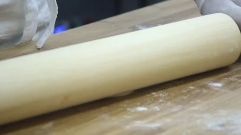 Roll out the dough with a rolling pin Stock Footage 70004119
