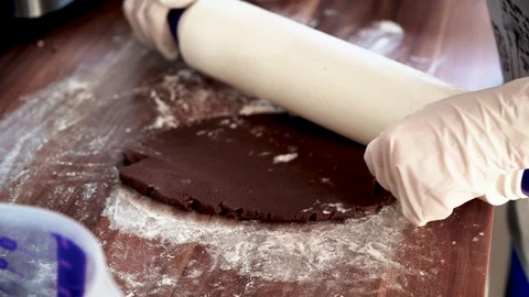 Roll out the dough with a rolling pin for Christmas cookies Stock Footage 121531329