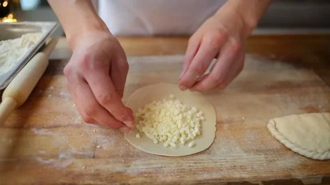 Roll out the dough with a rolling pin. Put the filling on the dough Stock-Footage 148311778