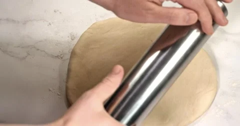 Roll out the dough with a rolling pin. Super slow motion Stock Footage 157654962