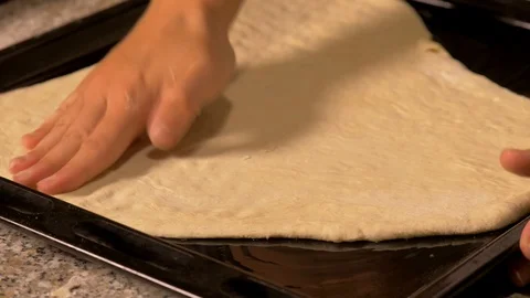 Roll out the dough with your hands to prepare the pizza Stock Footage 95244035