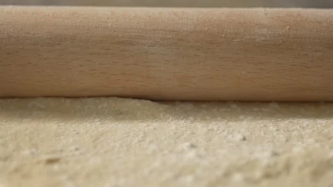 Roll out pizza base dough with a rolling pin. Stock Footage 266012517