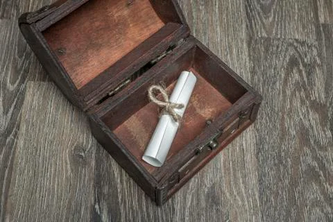 Roll paper in the old retro chest Stock Photos