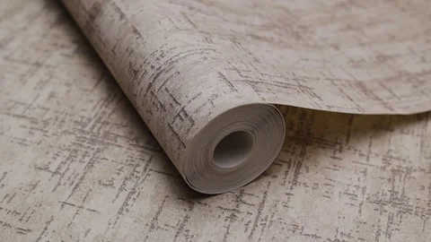 Roll of paper wallpaper on the wall with texture, camera movement slowly Stock Footage 306543104
