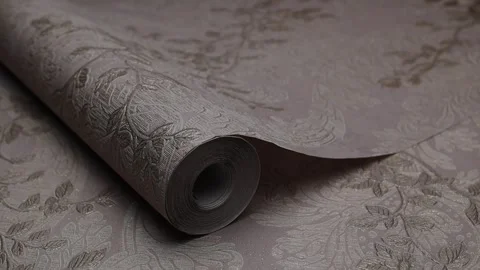 Roll of paper wallpaper on the wall with texture, camera movement slowly Stock Footage 306543315