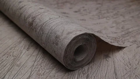 Roll of paper wallpaper on the wall with texture, camera movement slowly 库存影片 306543472