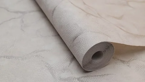 Roll of paper wallpaper on the wall with texture, camera movement slowly Stock Footage 306543733