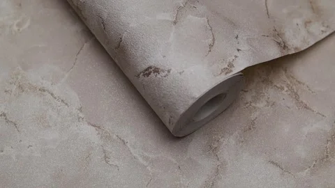 Roll of paper wallpaper on the wall with texture, camera movement slowly Stock Footage 306543980