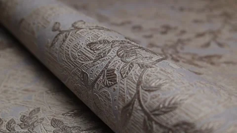 Roll of paper wallpaper on the wall with texture, camera movement slowly Stock Footage 306544091