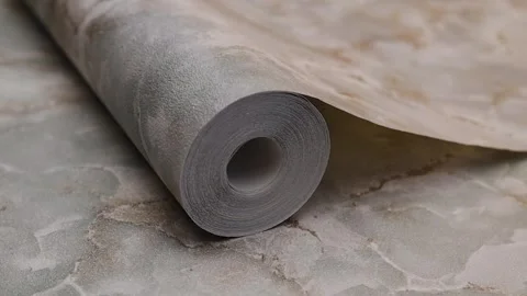 Roll of paper wallpaper on the wall with texture, camera movement slowly Stock Footage 306544466