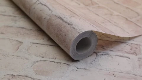 Roll of paper wallpaper on the wall with texture, camera movement slowly 库存影片 306544711