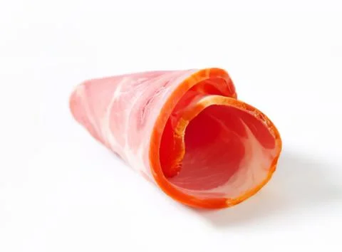 Roll of pink ham meat slice on plate Stock Photos