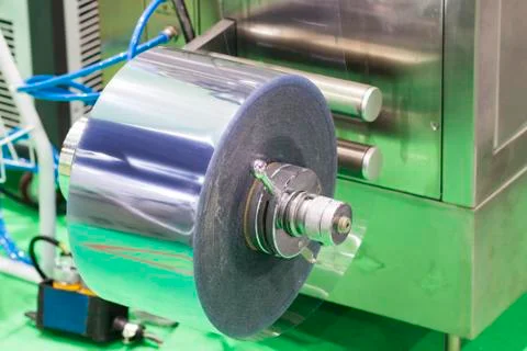 Roll of plastic for capsules packing machine Stock Photos