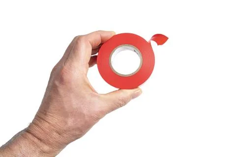 A roll of red electrical tape in the hand Stockfoto's