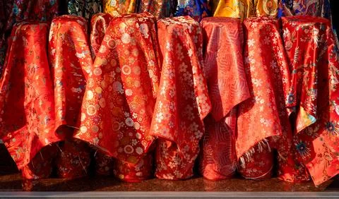 Roll red fabric, auspicious colors, dragons, swans, butterflies and flowers. Stock Photos