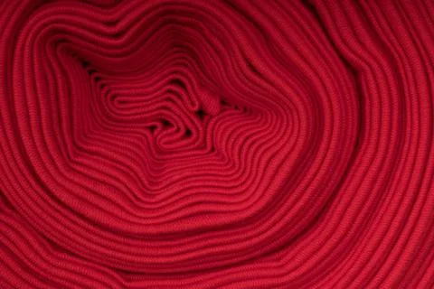Roll of red fabric, side view Stock Photos