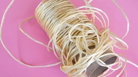 Roll of rope on pink background Stock Photos