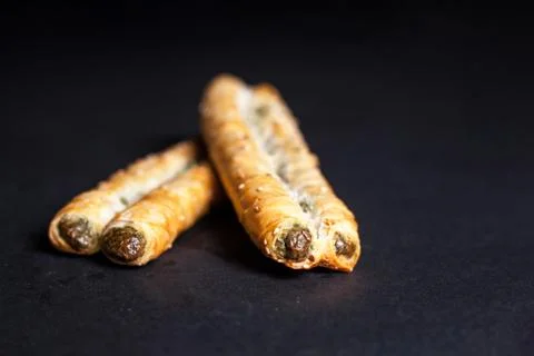 Roll with spinach on a dark background Stock Photos
