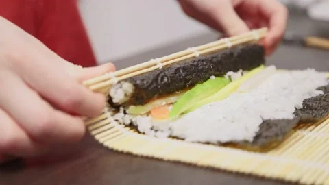 Roll sushi with bamboo mat Stock Footage 232811124