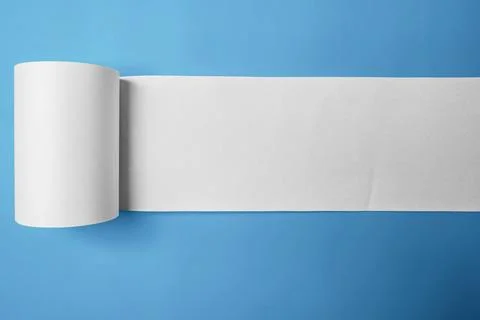 Roll of thermal paper for a receipt on a blue background. Copy space Stock Photos