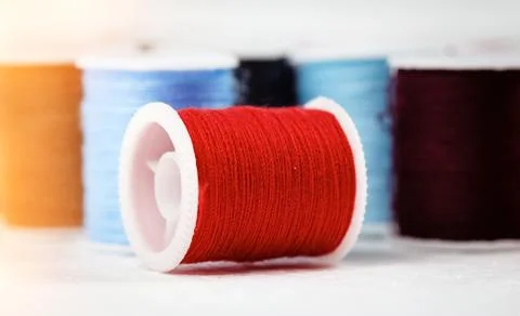 The roll of thread on background,show texture of red color thread,for needlew 스톡 사진