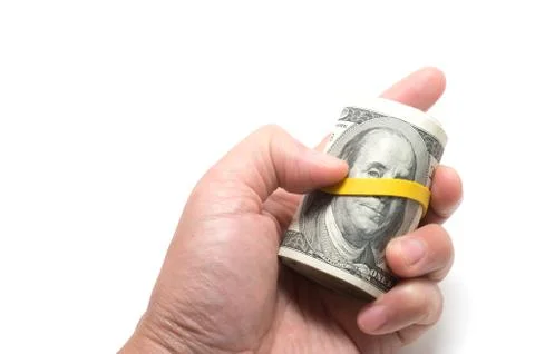 Roll of us banknotes with 100 dollars at the surface Stock Photos