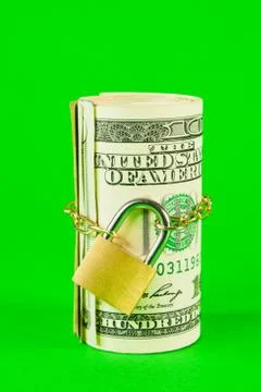 Roll of us dollars chained and locked Stock Photos