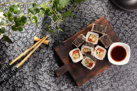 Roll with vegetables and fish paste with a sesame cap. Sushi menu bar. Japane Stock Photos