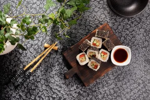 Roll with vegetables and fish paste with a sesame cap. Sushi menu bar. Japane Stock Photos