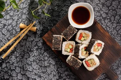 Roll with vegetables and fish paste with a sesame cap. Sushi menu bar. Japane Stock Photos