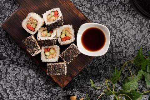 Roll with vegetables and fish paste with a sesame cap. Sushi menu bar. Japane Stock Photos