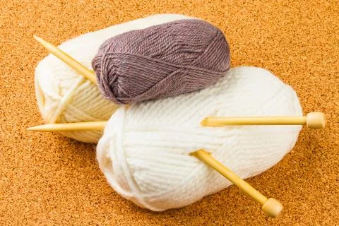 Roll of white and brown soft knitting yarn and wooden needles Stock Photos