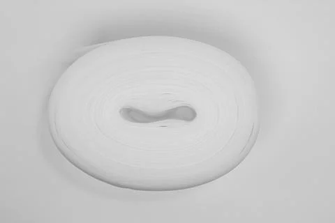 Roll of white material on plain background Fotos de archivo