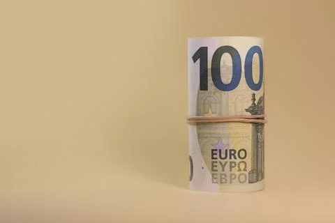 Rolled 100 euro banknotes bundle with rubber band Stock Photos