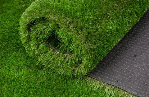 Rolled Artificial Grass Carpet on Display Stock-Fotos
