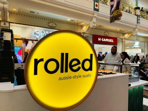 Rolled Aussie style sushi stand in Manchester shopping mall with shoppers a.. Photos