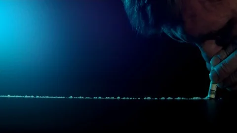 A rolled banknote snorting a long line of cocaine powder. Stock Footage 102728653