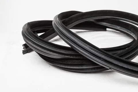 Rolled up black rubber sealant for elements of the car body, doors or trunk.. Stock Photos