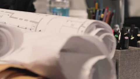 A Rolled up blueprints on desk Stock Footage 155538831