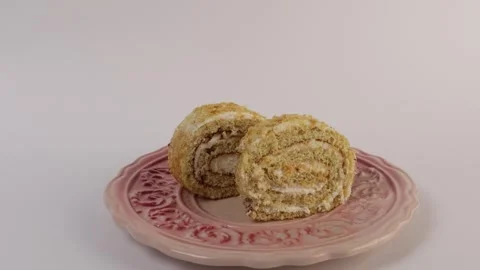 Rolled cake slice showing cream layers and soft sponge texture. Stock Footage 308922814