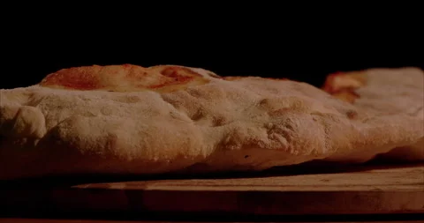 Rolled Calzone Rotating Closeup, Black Background Stock Footage 130941583