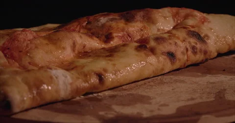 Rolled Calzone Rotating Closeup, Black Background, Oiled 04 Stock Footage 130942112