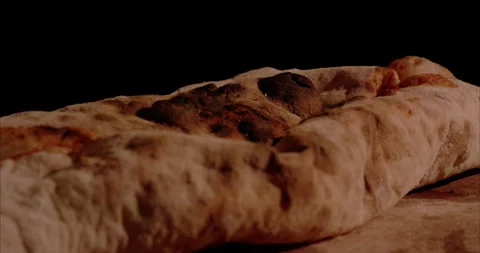 Rolled Calzone Rotating Closeup, Black Background Stock Footage 130943811