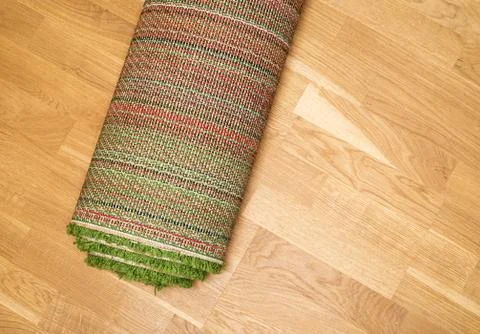 Rolled carpet on the floor Stock Photos