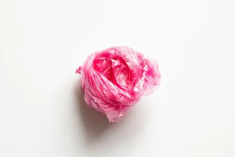Rolled up colored polythene bag in the form of a ball on a white background.. Stock Photos