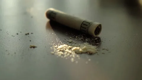 Rolled dollar bill against the background of heroin or cocaine powder, close-up Stock-Footage 194506286