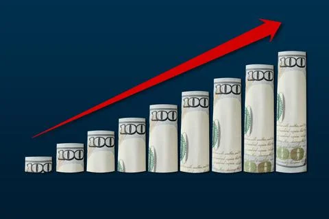 Rolled up dollar bills in an ascending chart with a red up arrow. Stock Photos
