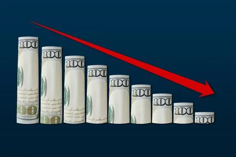 Rolled up dollar bills falling graph with red down arrow. Stock Photos