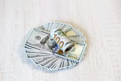 Rolled-up dollar bills Stock Photos