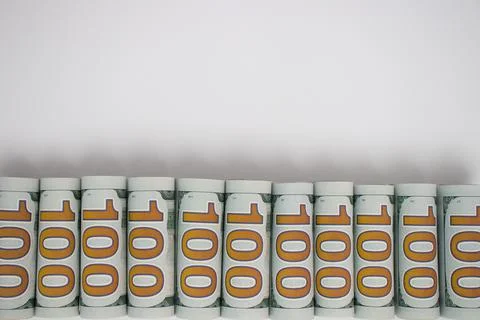 Rolled dollars on white with copy space. American money. Stock Photos